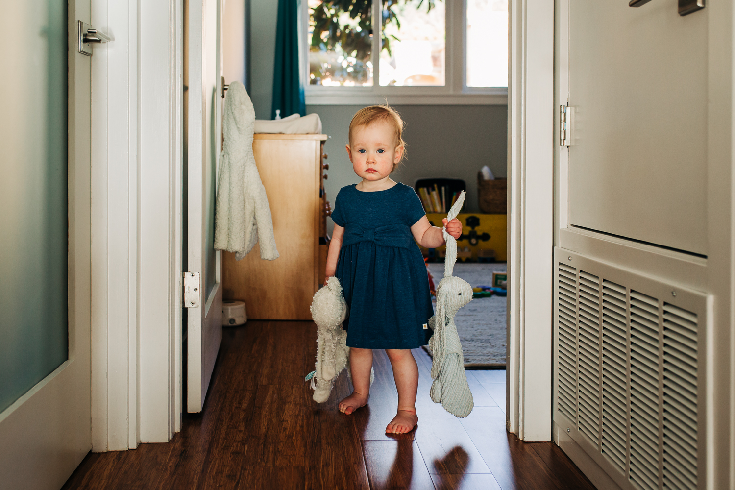 Baby staying in hallway holding her lovies | San Francisco Photographer