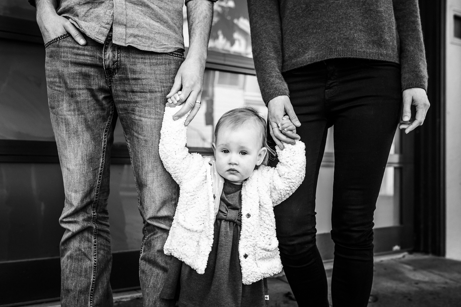 Portrait of a little girl holding her parents hands | SF Baby Photography