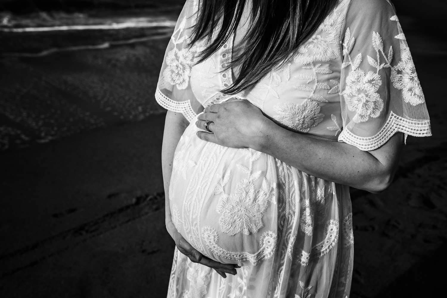 black and white photo of baby bump with woman wearing a long white dress | East Bay Maternity Photographer
