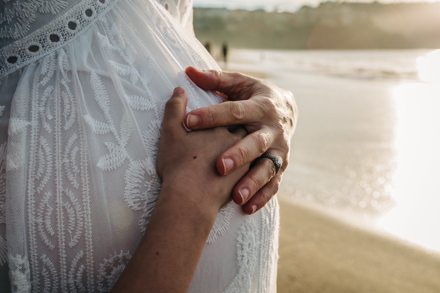 Mother and daughter holding hands on top of mother's baby bump | Bay Area Maternity Photography