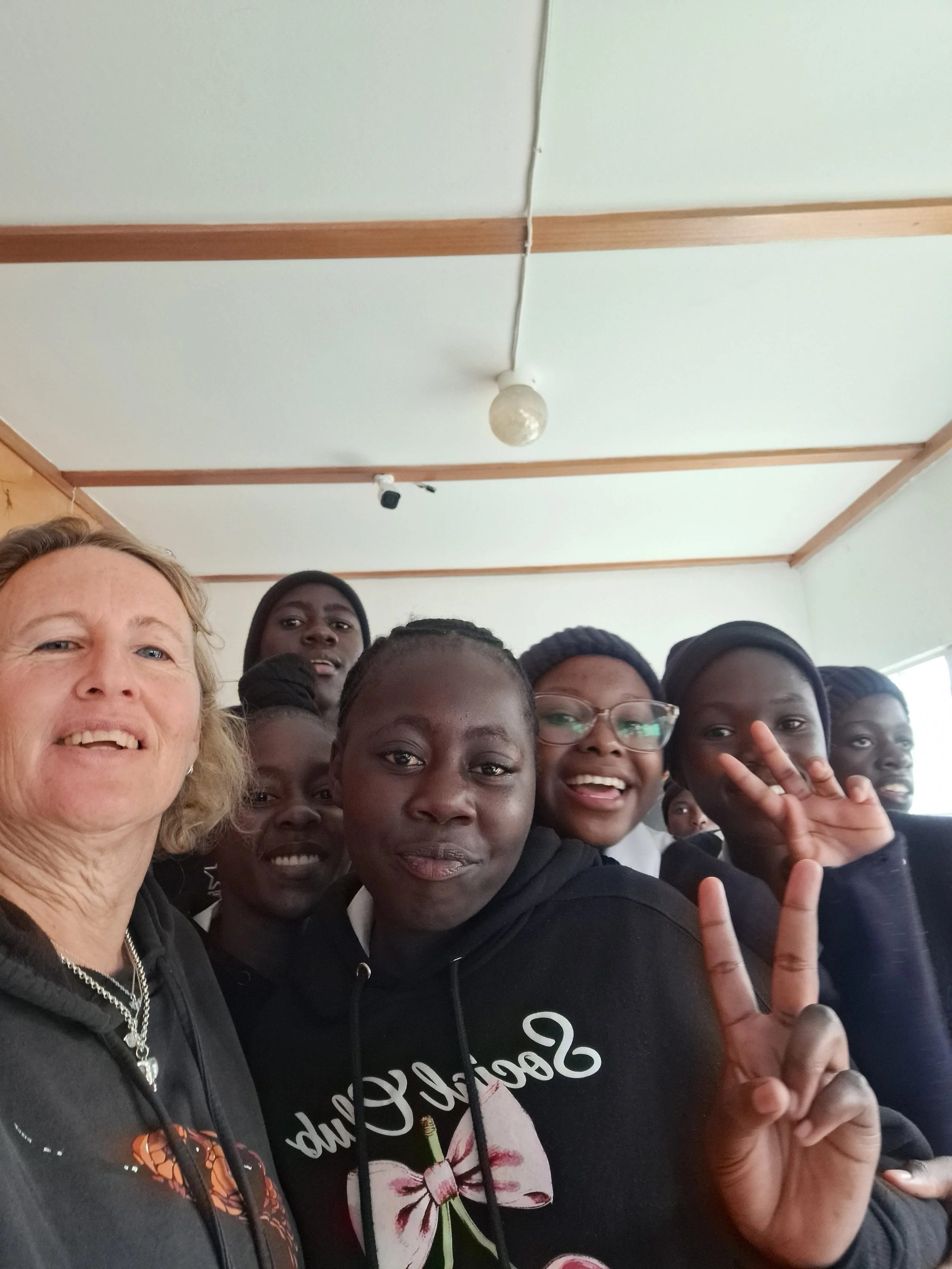 A school group enjoying their visit to the Living Desert Snake Park to learn about Namibia's fascinating reptiles and how to conserve them. A large collection of snakes including black mambas, cobras and adders on display for tourists and local famil