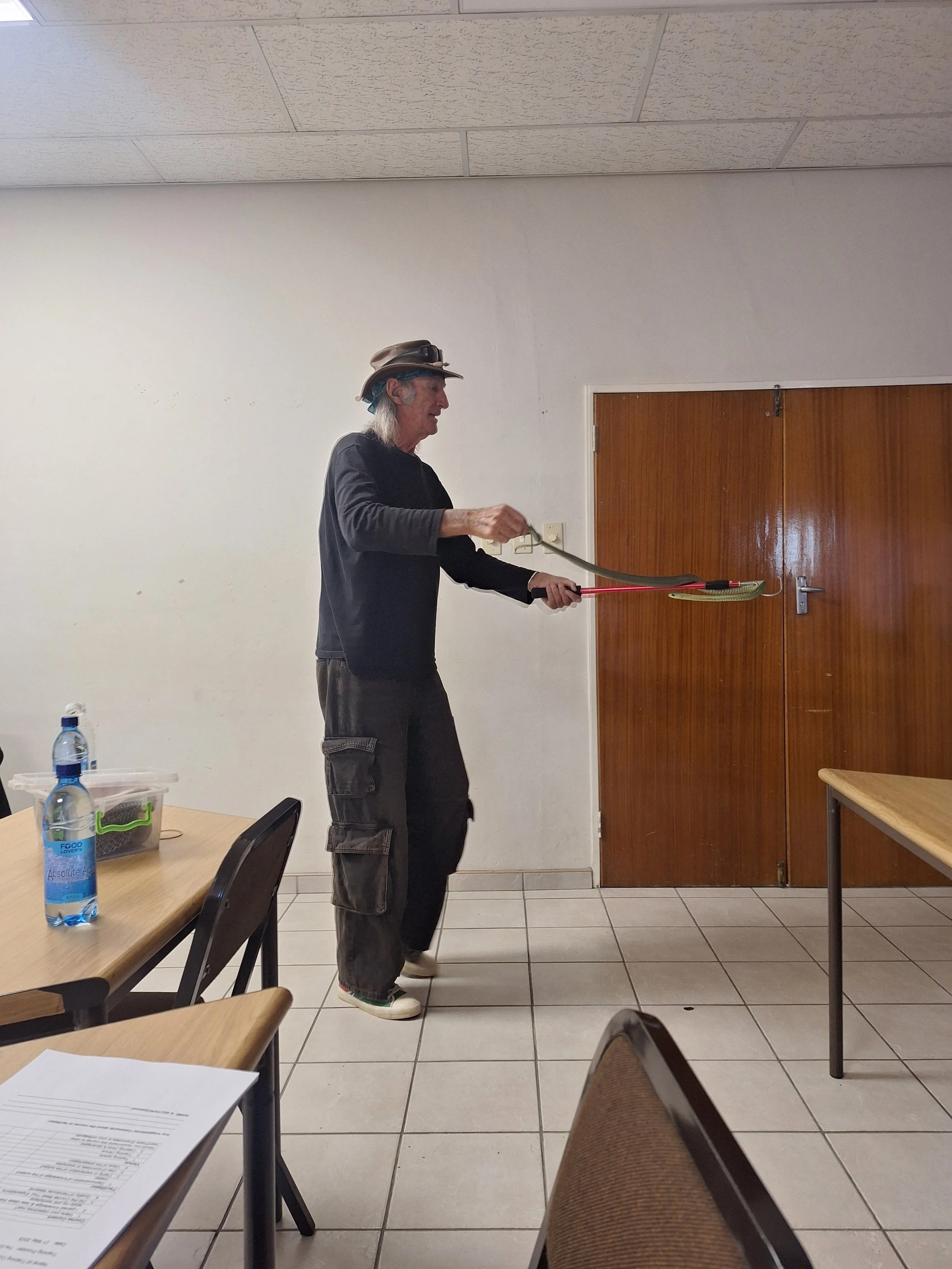 Stretch teaching a group of snake handling trainees some of the finer details of how to identify different species of snakes during the snake awareness and safe handling course.