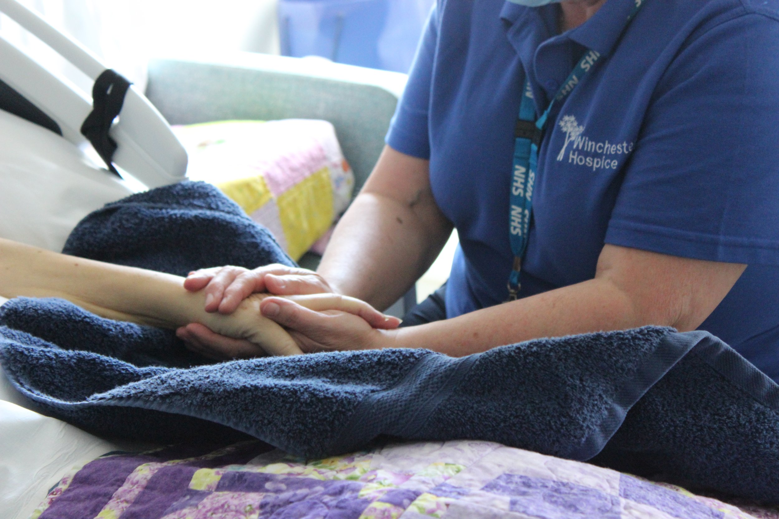  Staff member holding hands with a patient 