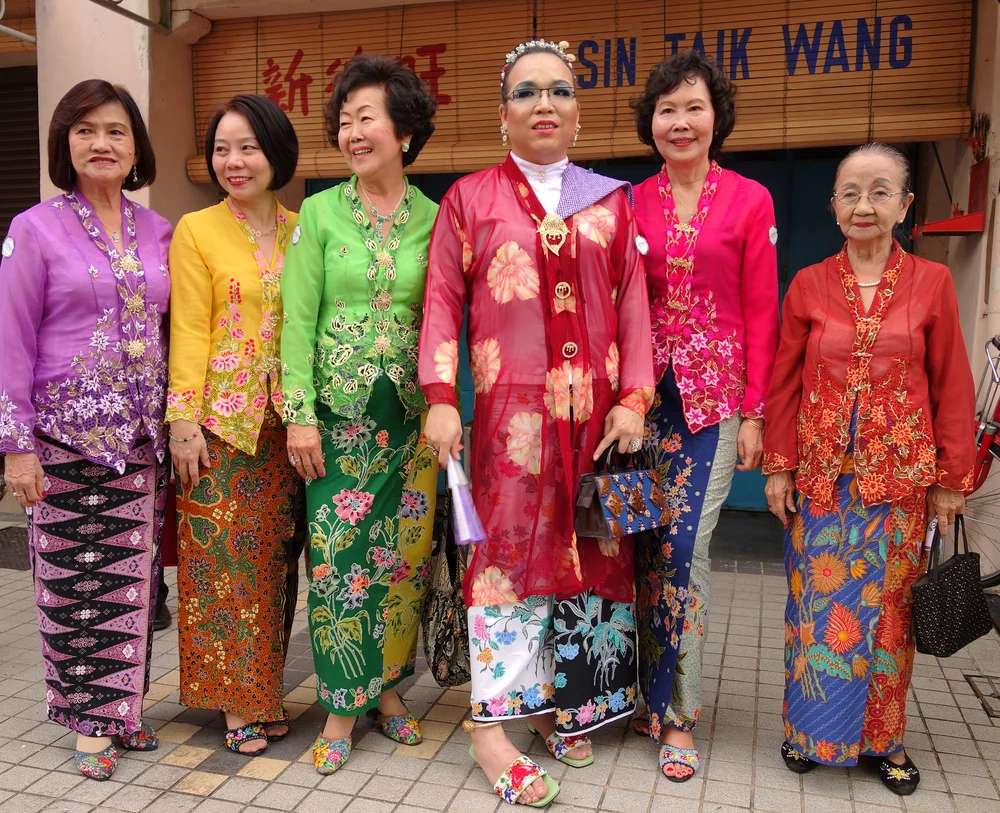 Peranakan women wearing traditional kebaya (blouse) and kasut manik (slippers)