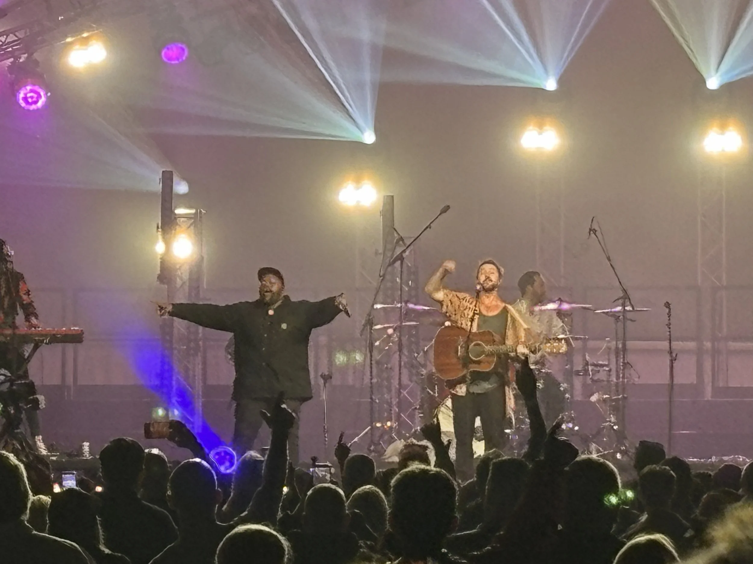 Motheo Moleko and Jeremy Loops raise their arms to rally the Battersea Park crowd during Jeremy Loops’ headline set at Sounds of South Africa concert on Friday 28 August 2026