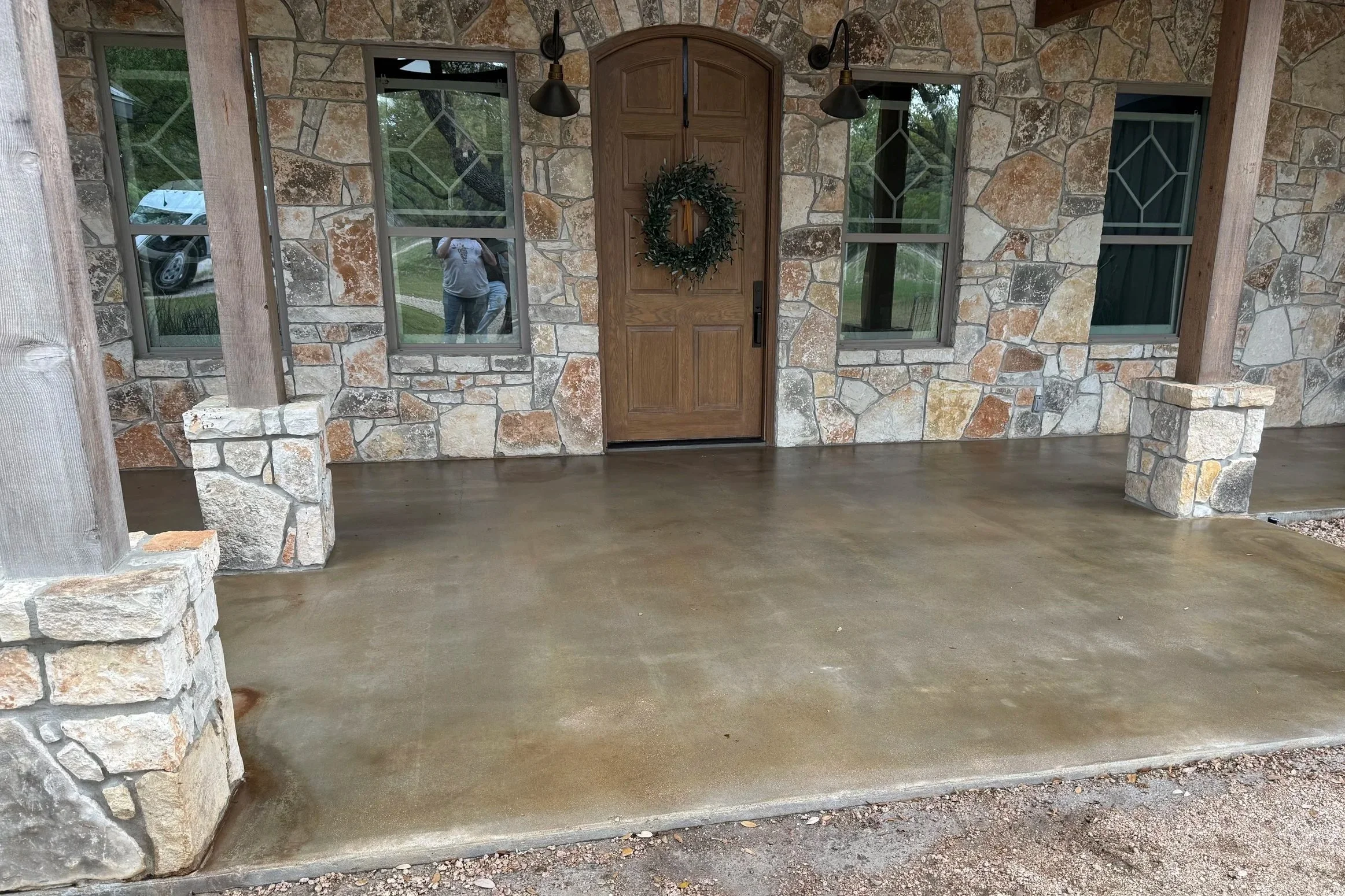 A porch that has been refinished with ground & sealed concrete.