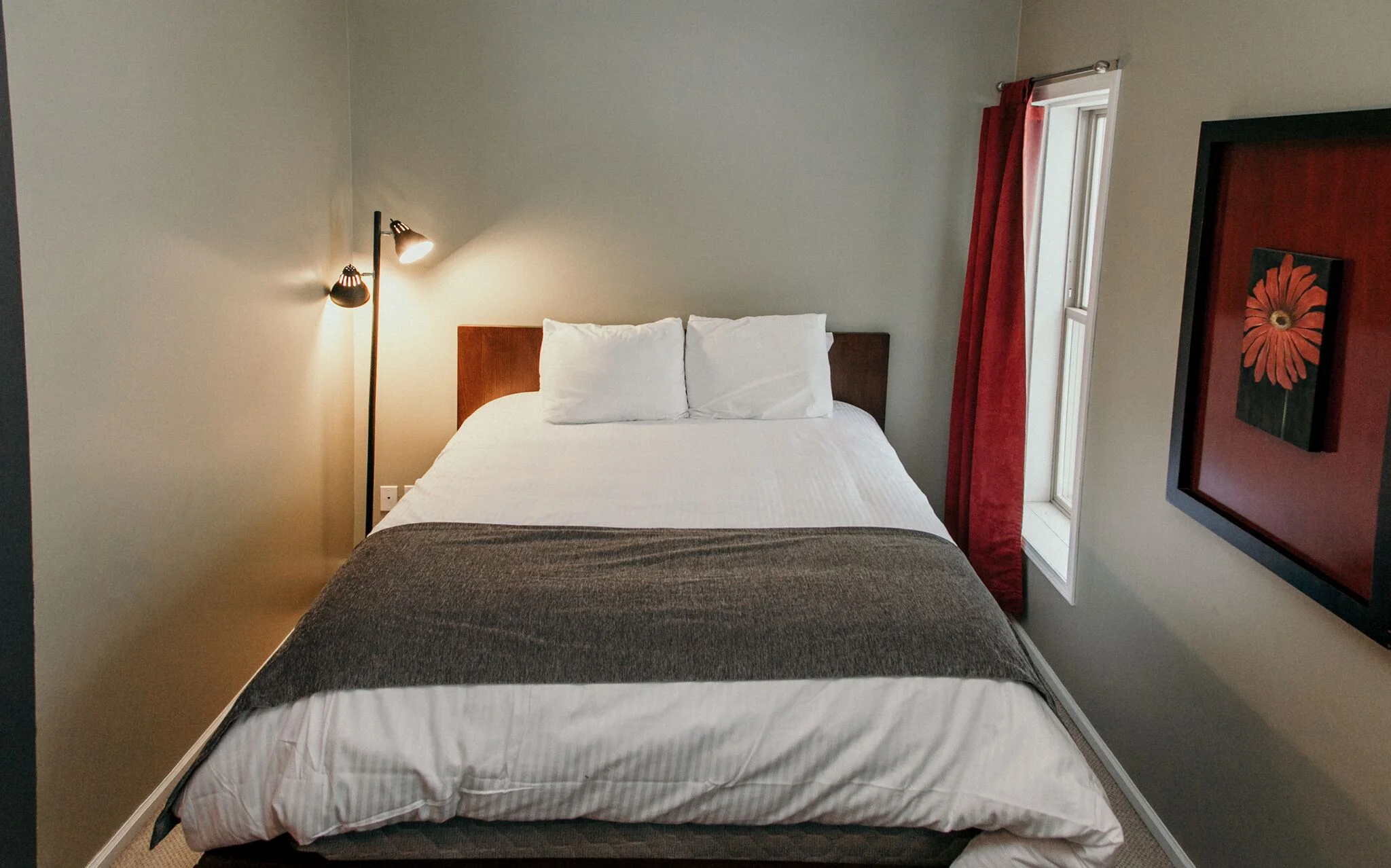 Queen Suite, featuring a full kitchen, bathroom, living space, and bunk bed.