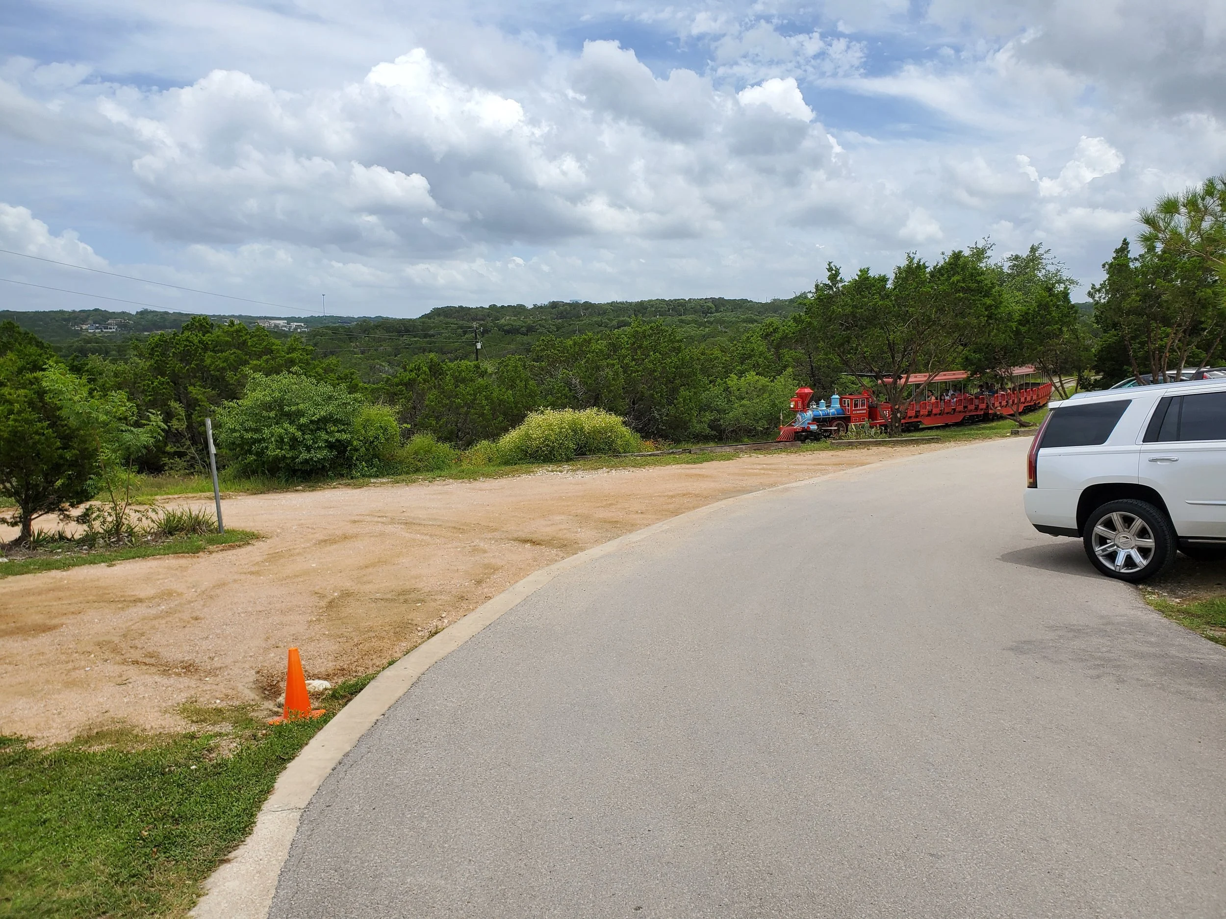 View from the entrance looking out to the surrounding hillsides. Train exits zoo to explore the surrounding area.