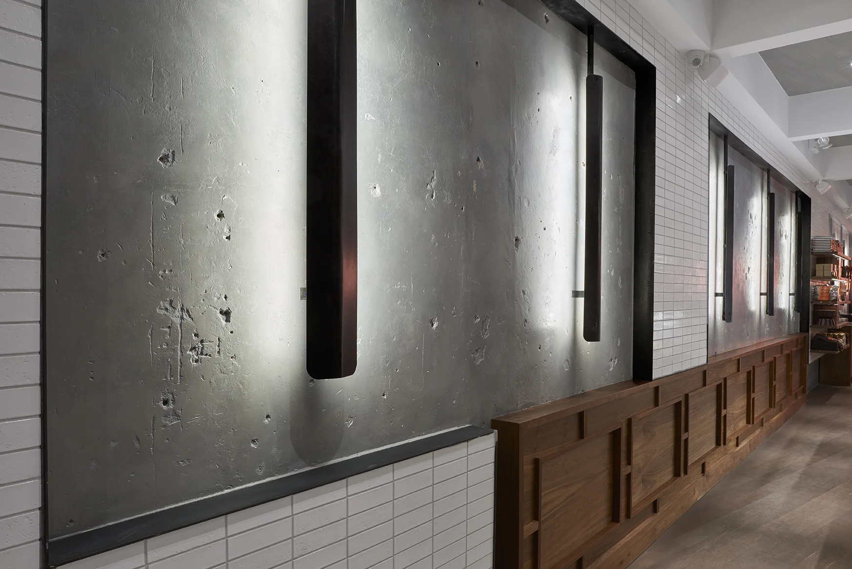 Wall of Baked Tribeca with multiple materials including: cement, ceramic tile, and wood. MEP designed by 2L Engineering, a New York firm.
