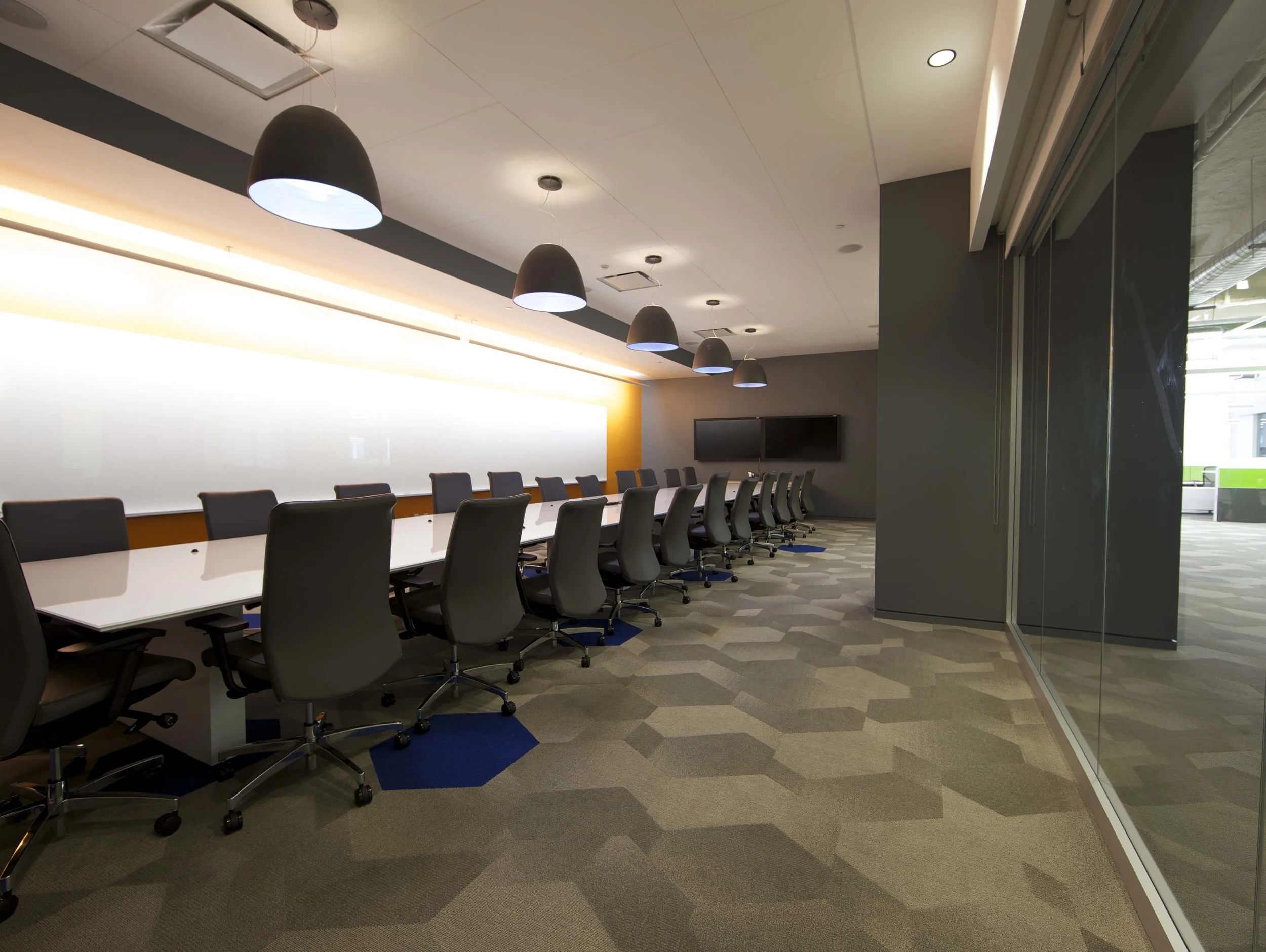 Conference room with hexagon carpet tiles in the Rocketfuel headquarters. MEP by 2L Engineering.