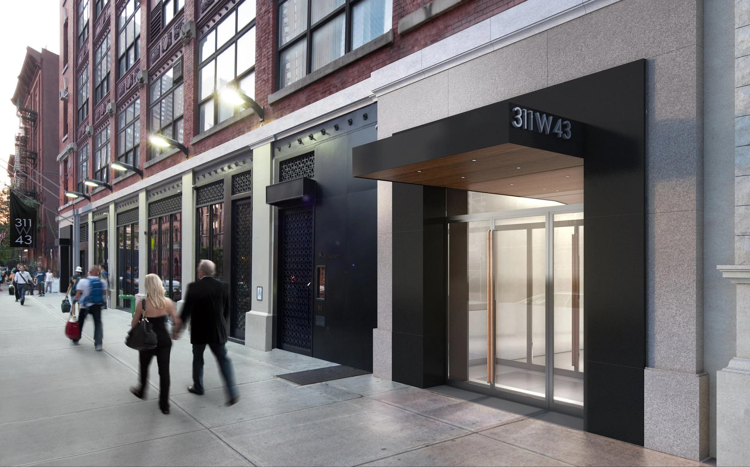 People on the sidewalk at dusk passing by the offices of Atlas Capital on 311 West 43rd Street. MEP provided by 2L Engineering.