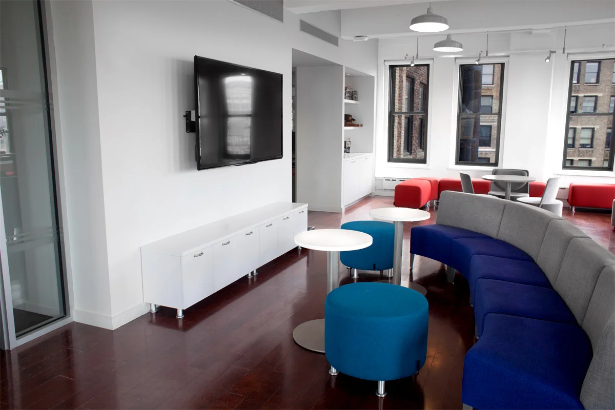 Break room and lounge area with a TV and board games in the office of Publishers Clearing House. MEP provided by 2L Engineering.