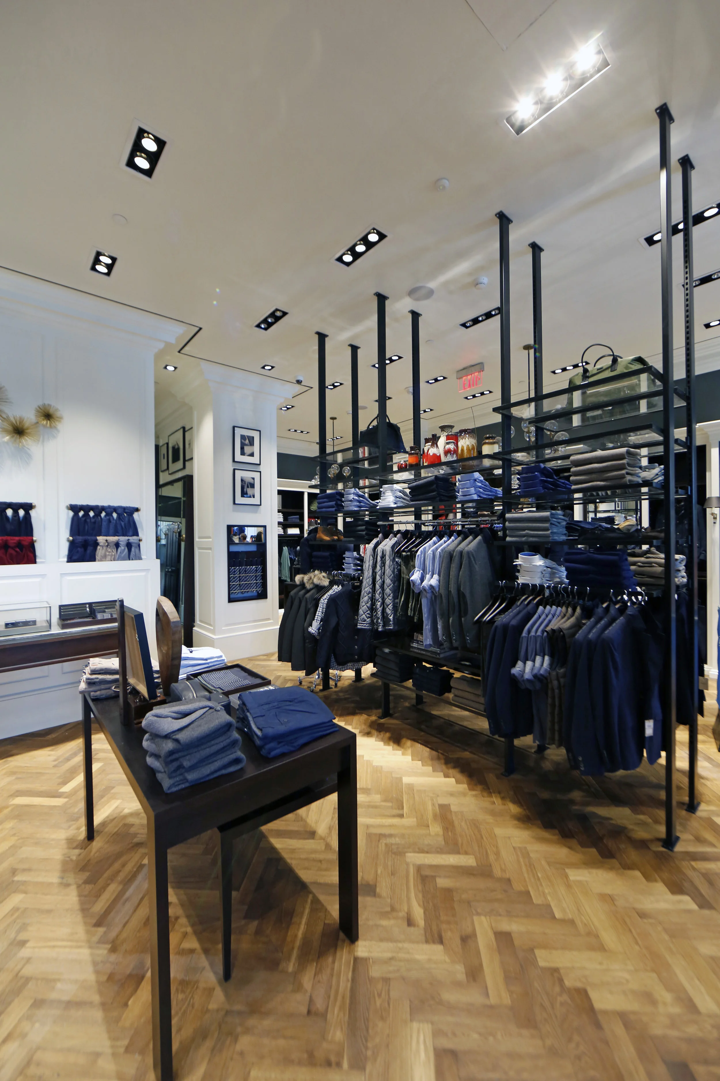 Dress shirts, collared shirts, outerwear, and scarves on display in Hacket London, Woodbury Common Premium outlet, New York. MEP designed by 2L Engineering.