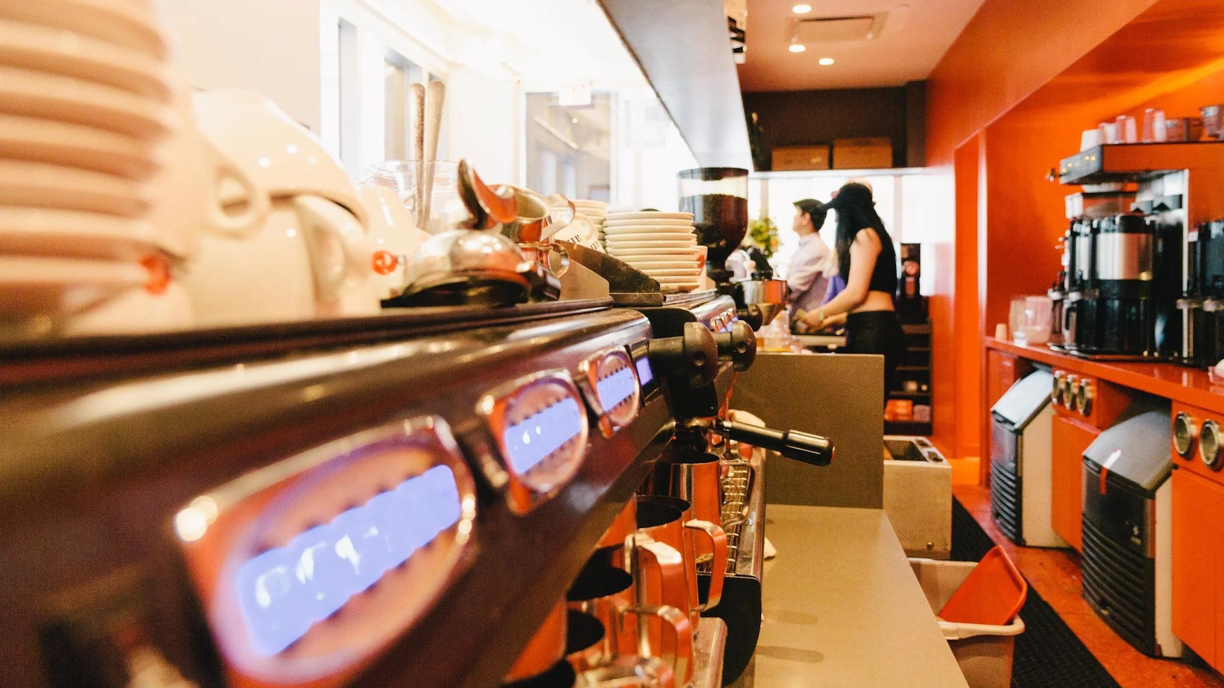 Detail shot of behind the bar, showing the coffee machines, kitchenware and other cafe items at Robusta Espresso Bar. MEP designed by 2L Engineering.