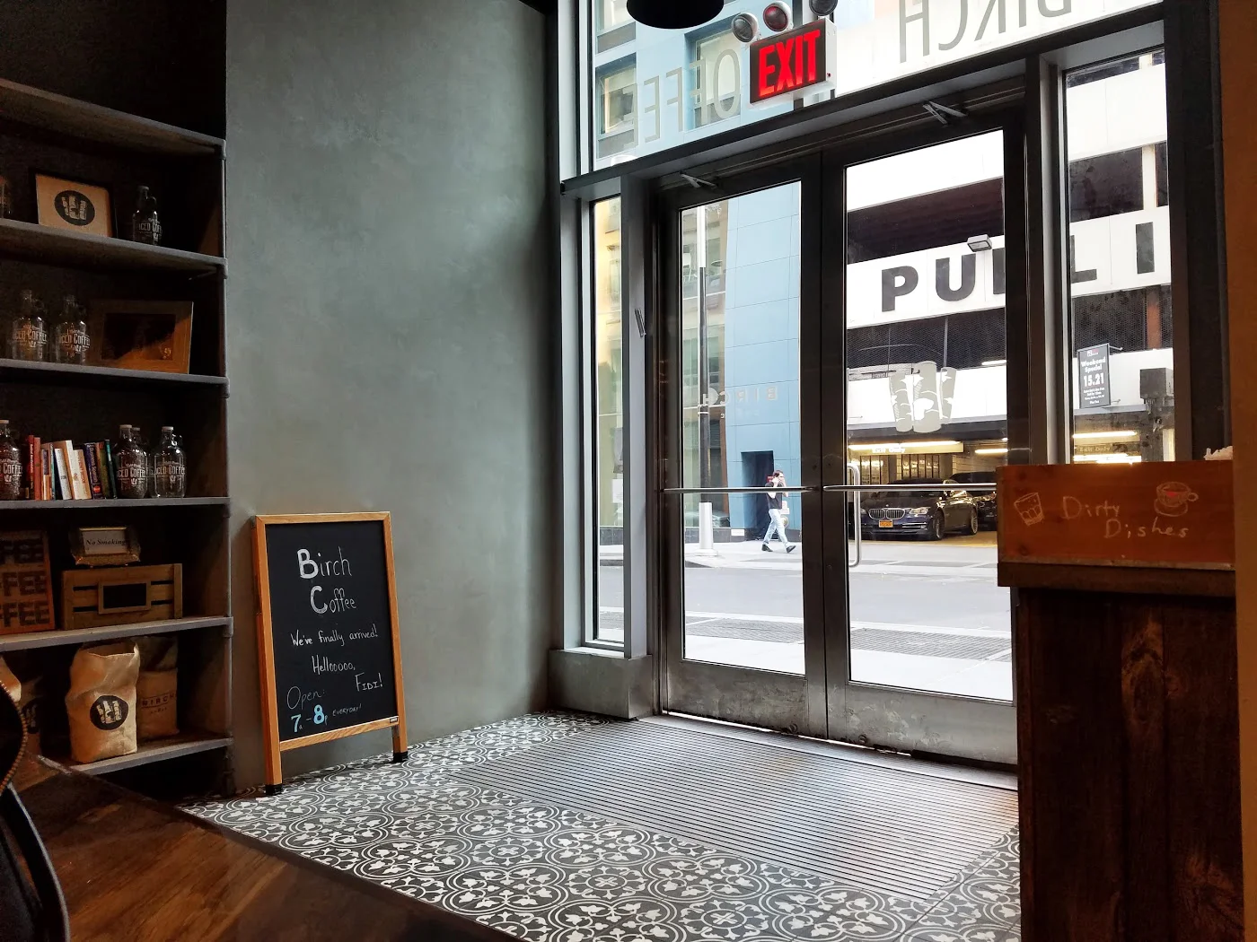 Entrance for Birch Coffee, with a shelf to the side holding brand products. MEP provided by 2L Engineering.