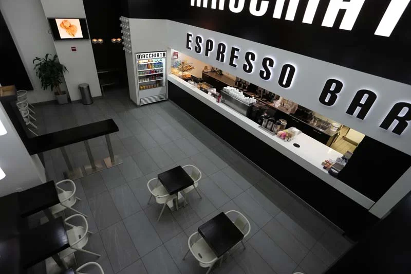 Birds eye view of the seating area and bar of Macchiato Espresso Bar, with MEP designed by 2L Engineering.