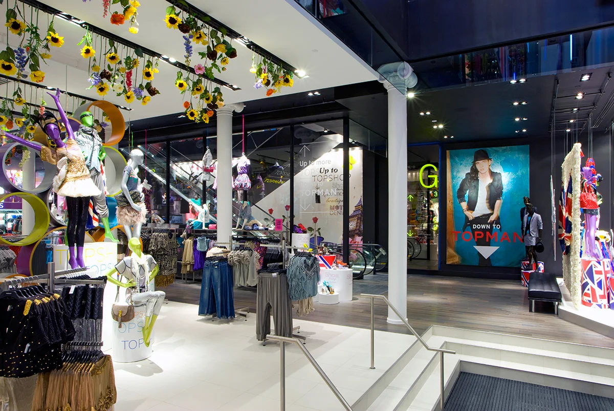 Fun, floral decor hanging from the ceiling over the women's' clothing area of Topshop / Topman in New York. MEP designed by 2L Engineering.