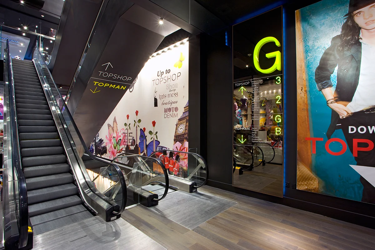 Escalators with signage directing customers to Topshop or Topman, a British retail store located in New York City. MEP provided by 2L Engineering.