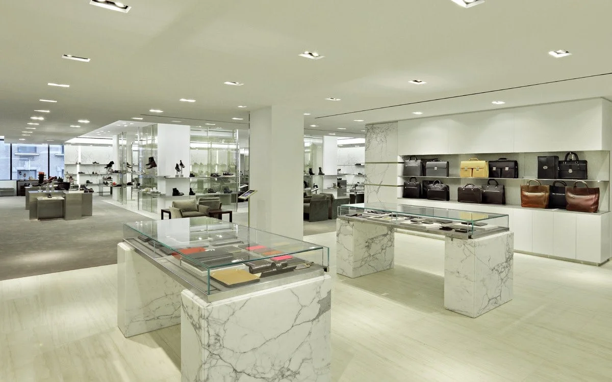Shoes, bags, and wallets on display in Barney's New York for customers to view. MEP designed by 2L Engineering.