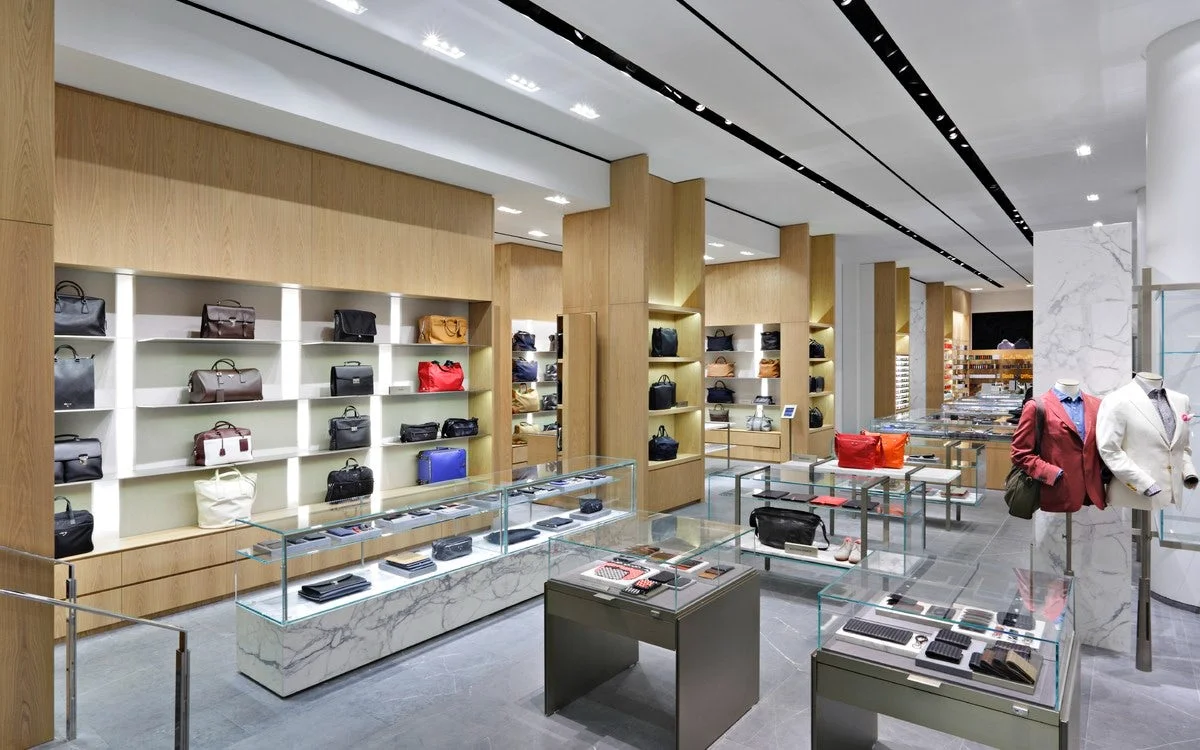 Luggage and other types of bags with well-dressed mannequins in Barney's New York. MEP designed by 2L Engineering.