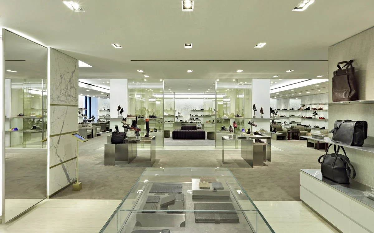 View of the mens shoewear section from mens accessories, wallets, and bags at Barney's New York. MEP provided by 2L Engineering.