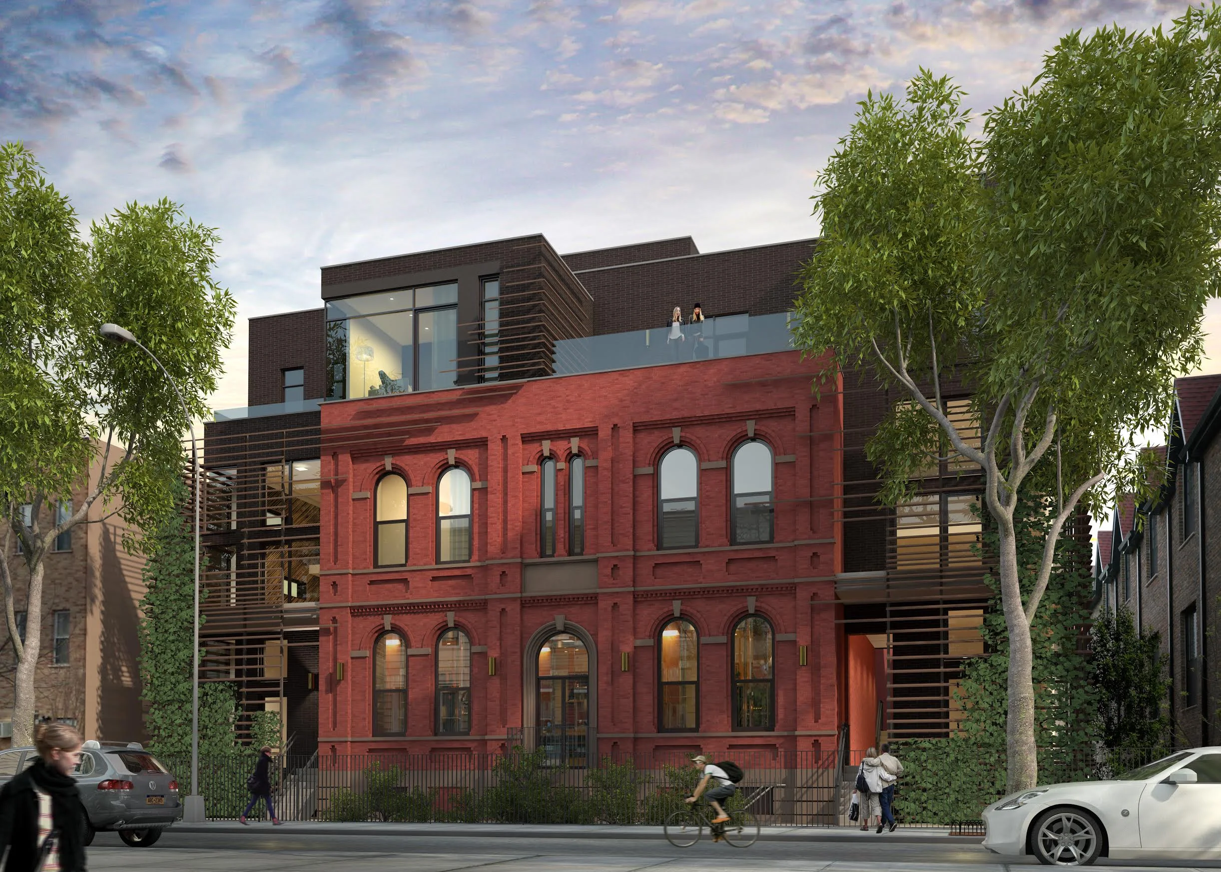 View of the exterior of a residential building with red brick and modern additions. MEP designed by 2L Engineering.