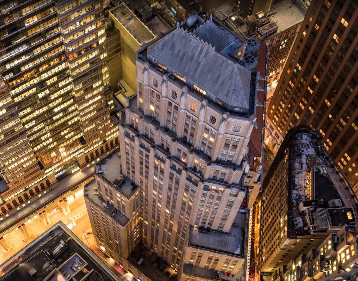 Birds eye view of a luxury residential building and the different balconies lit up at night. MEP provided by 2L Engineering. 