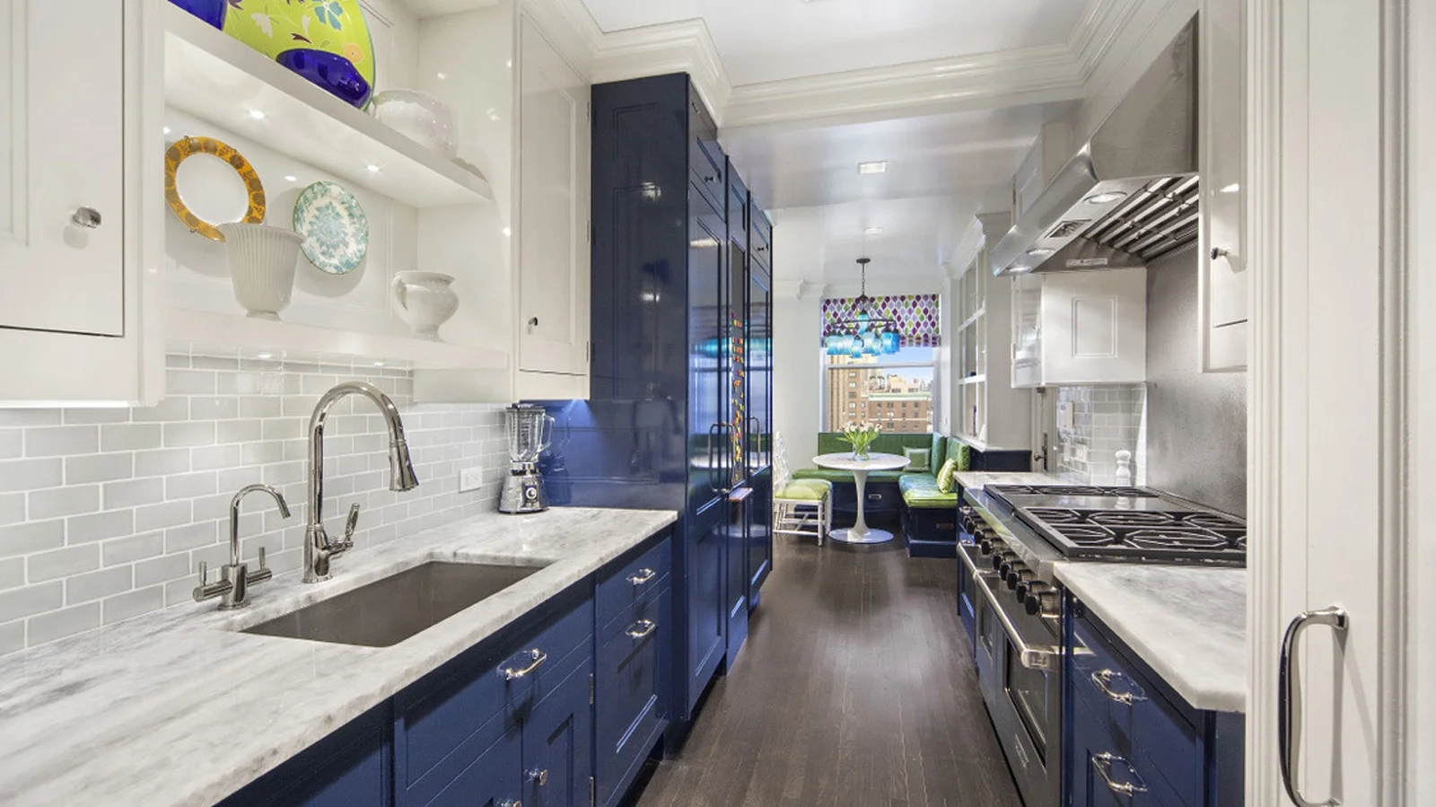 Kitchen with a breakfast nook and blue cabinets. MEP designed by 2L Engineering.