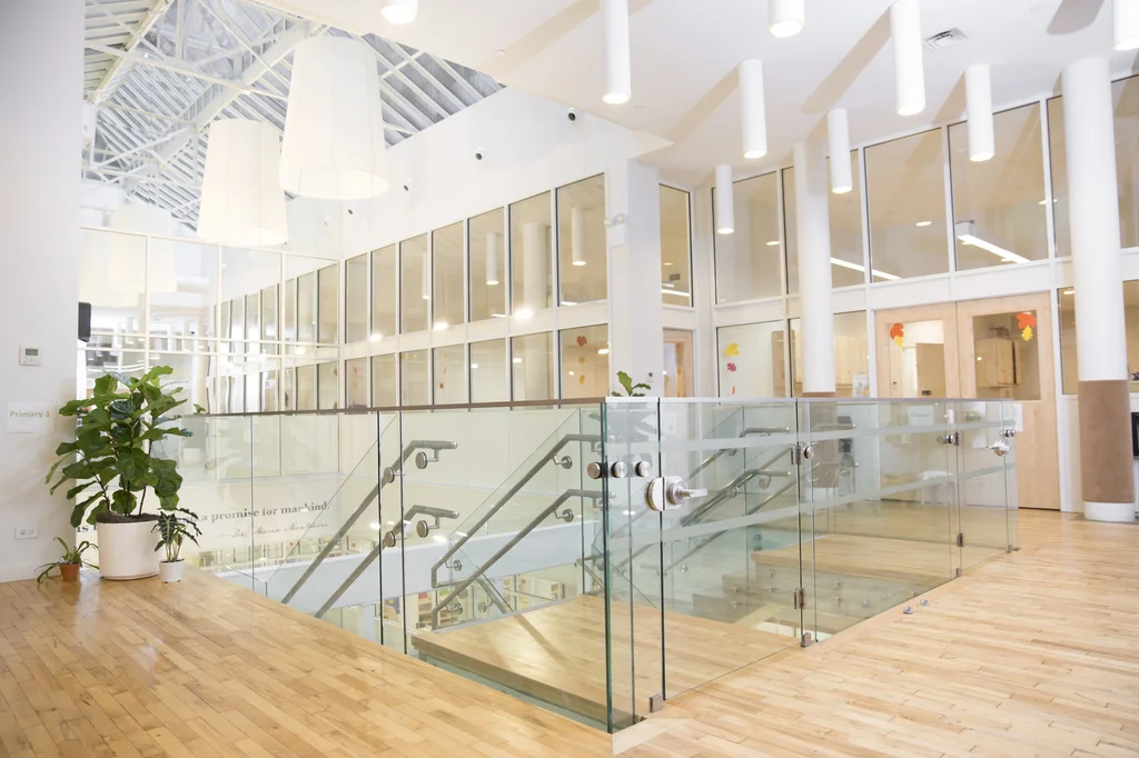 Wood and glass accented staircase in the Flatiron location of the Montessori School in New York City. MEP provided by 2L Engineering.