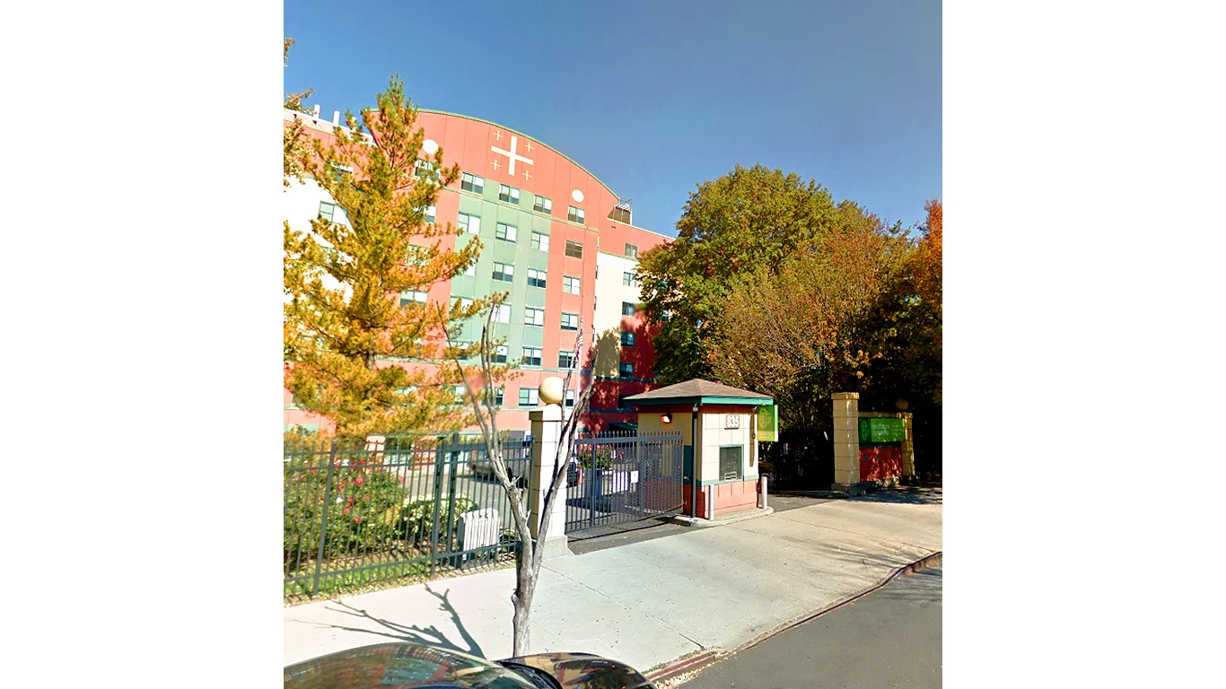 Parking entrance and facade view from the sidewalk of the Henry Bishop Nursing Home in Brooklyn, New York. MEP provided by 2L Engineering.