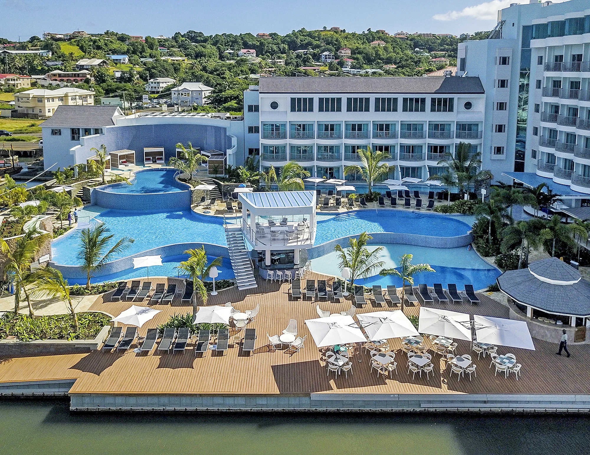 Wideshot of the pools, lounge, and bar and eating area at the Harbor Club Hotel in St. Lucia. MEP designed by 2L Engineering.