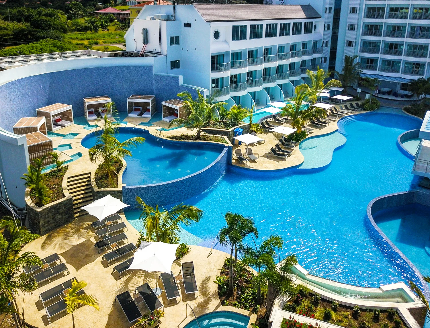 The pools and couples lounge area by an elevated pool at the Harbor Club Hotel in St. Lucia. MEP provided by 2L Engineering.