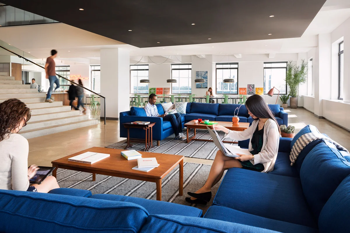 People working in the lounge area of Droga5, beside the staircase and break area. MEP provided by 2L Engineering.