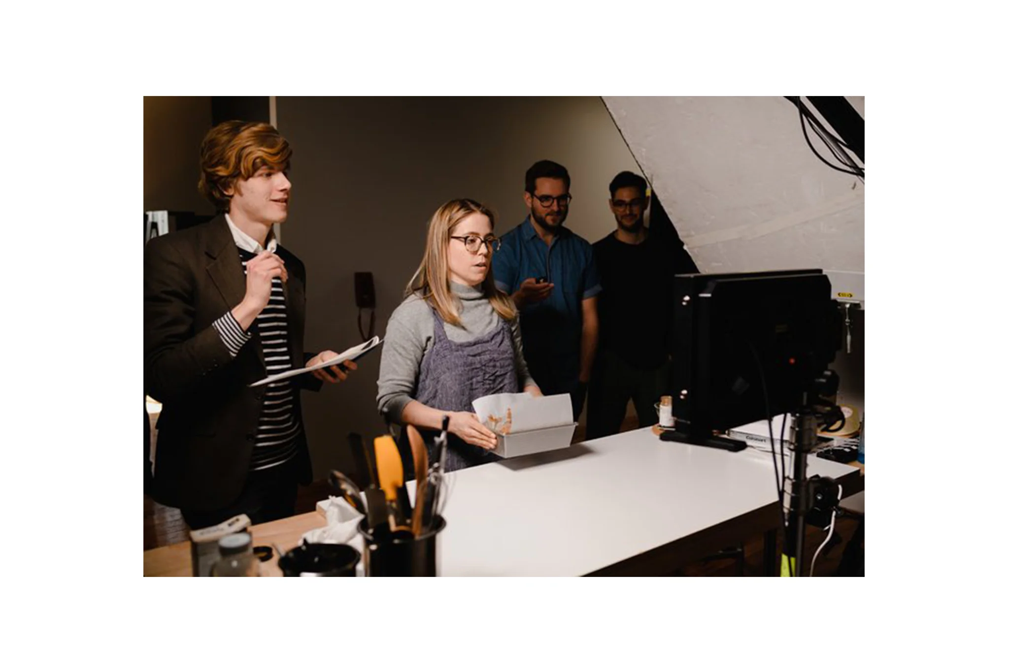A baker and film crew review footage at the kitchen studio of Conde Nast, located in Brooklyn, New York. MEP provided by 2L Engineering.