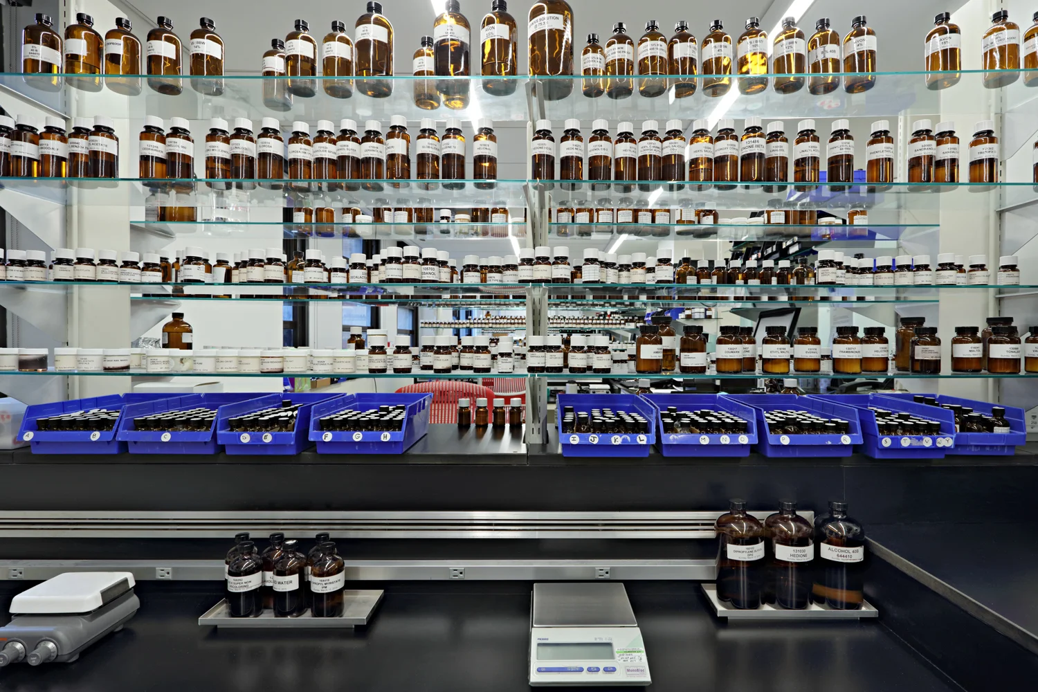 Various fragrances and oils in bottles on multiple shelves at the labs of Symrise in New York. MEP designed by 2L Engineering.