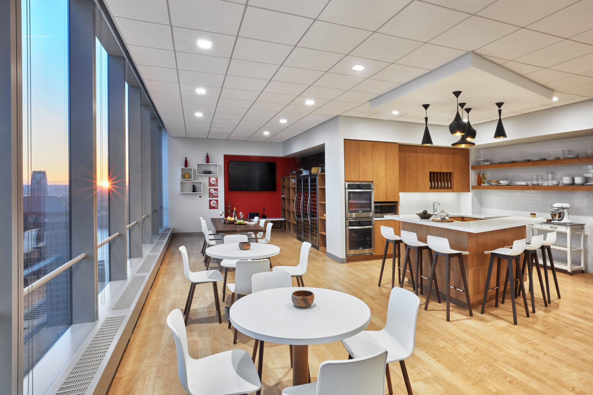 Break room with kitchenette and multiple seating areas for the employees of Padilla CRT in New York. MEP designed by 2L Engineering.