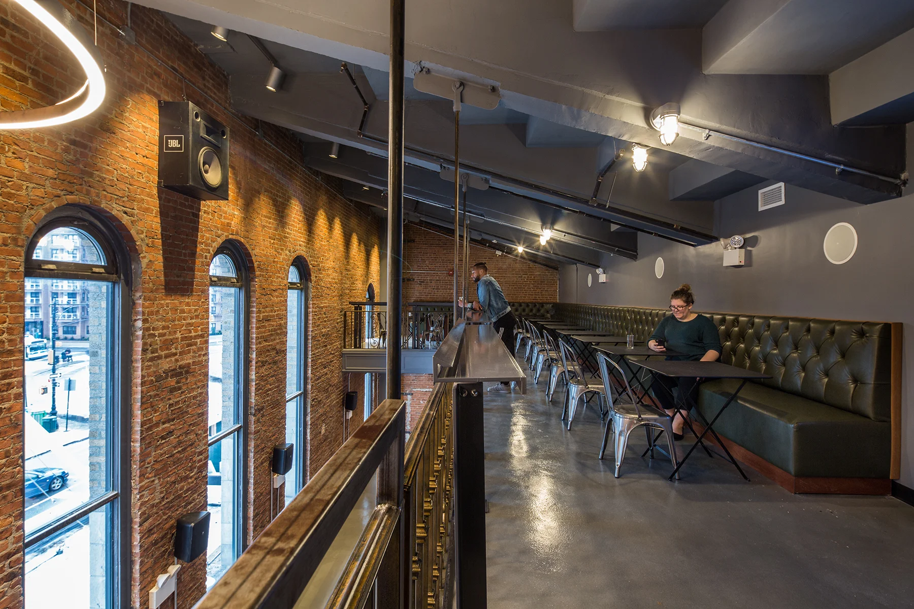 Upper level of the exposed brick interior of the Nitehawk Cinema at 188 Prospect Park West in Brooklyn, with MEP-FP engineering services provided by 2L Engineering.