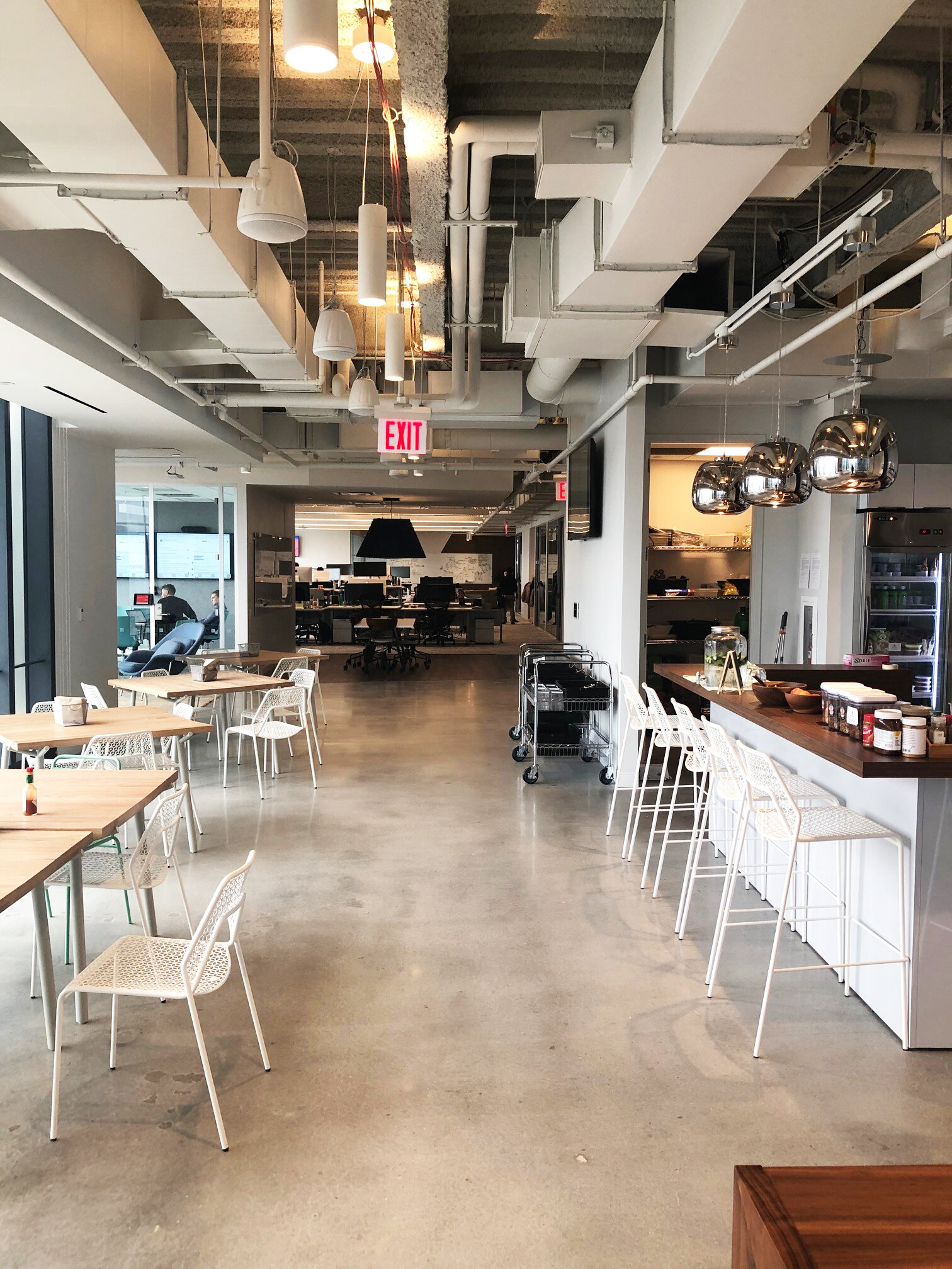 Interior of the pantry and hall at the 3 WTC Asana office with MEP-FP engineering services provided by 2L Engineering.