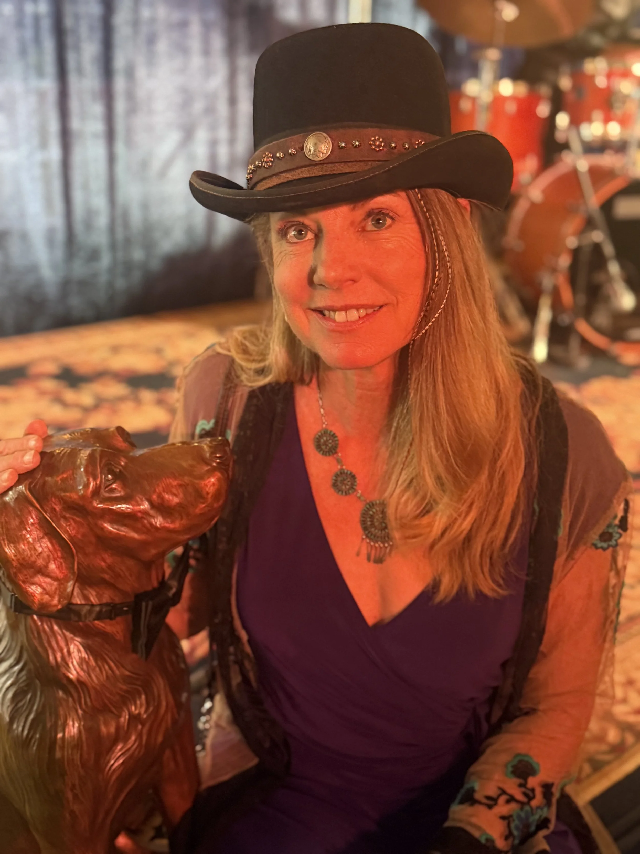Montana artist Amber Jean with her bronze dog sculpture Jake at the Livingston HealthCare Alpenglow Gala.