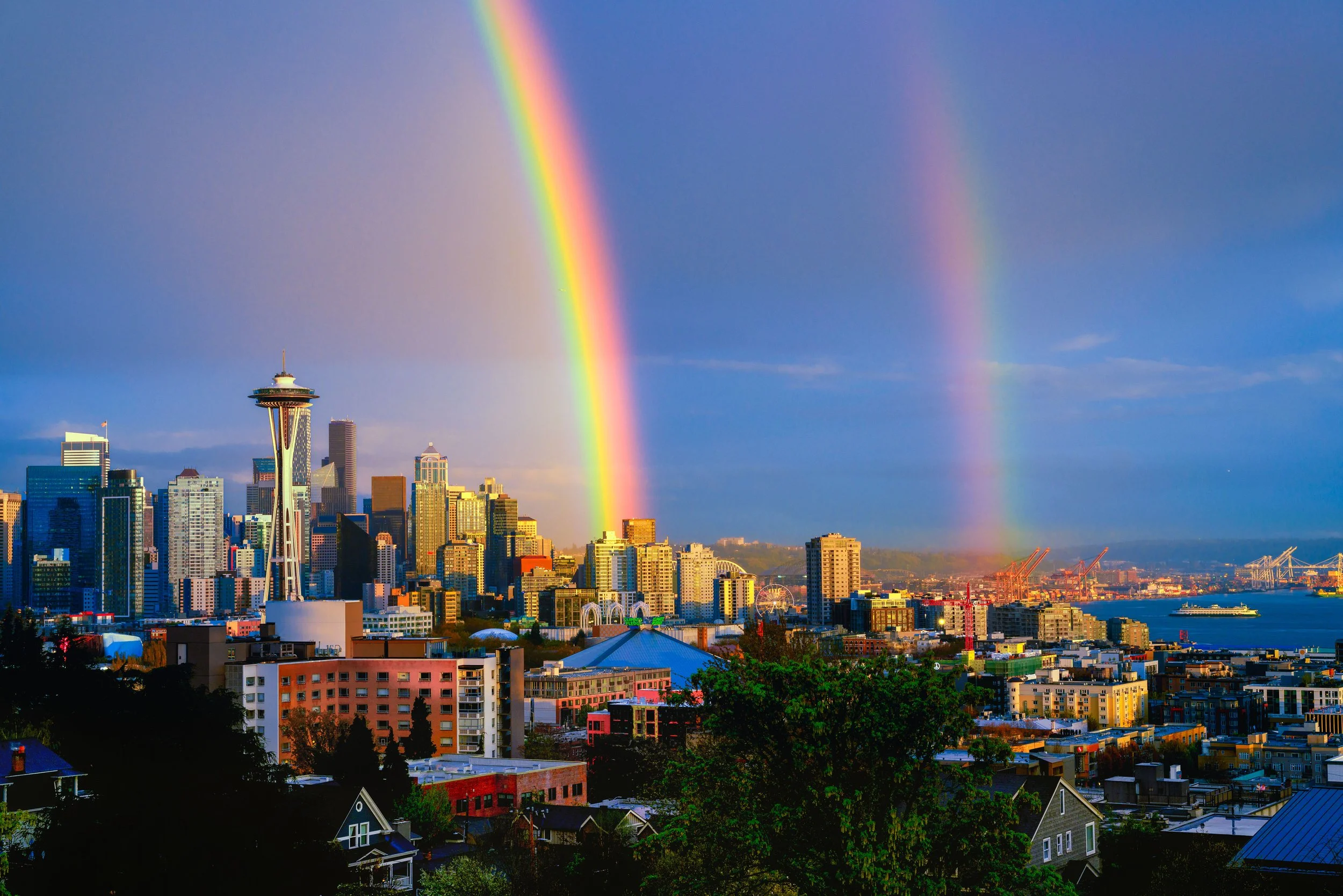 A Seattle landscape with a double rainbow in the sky.