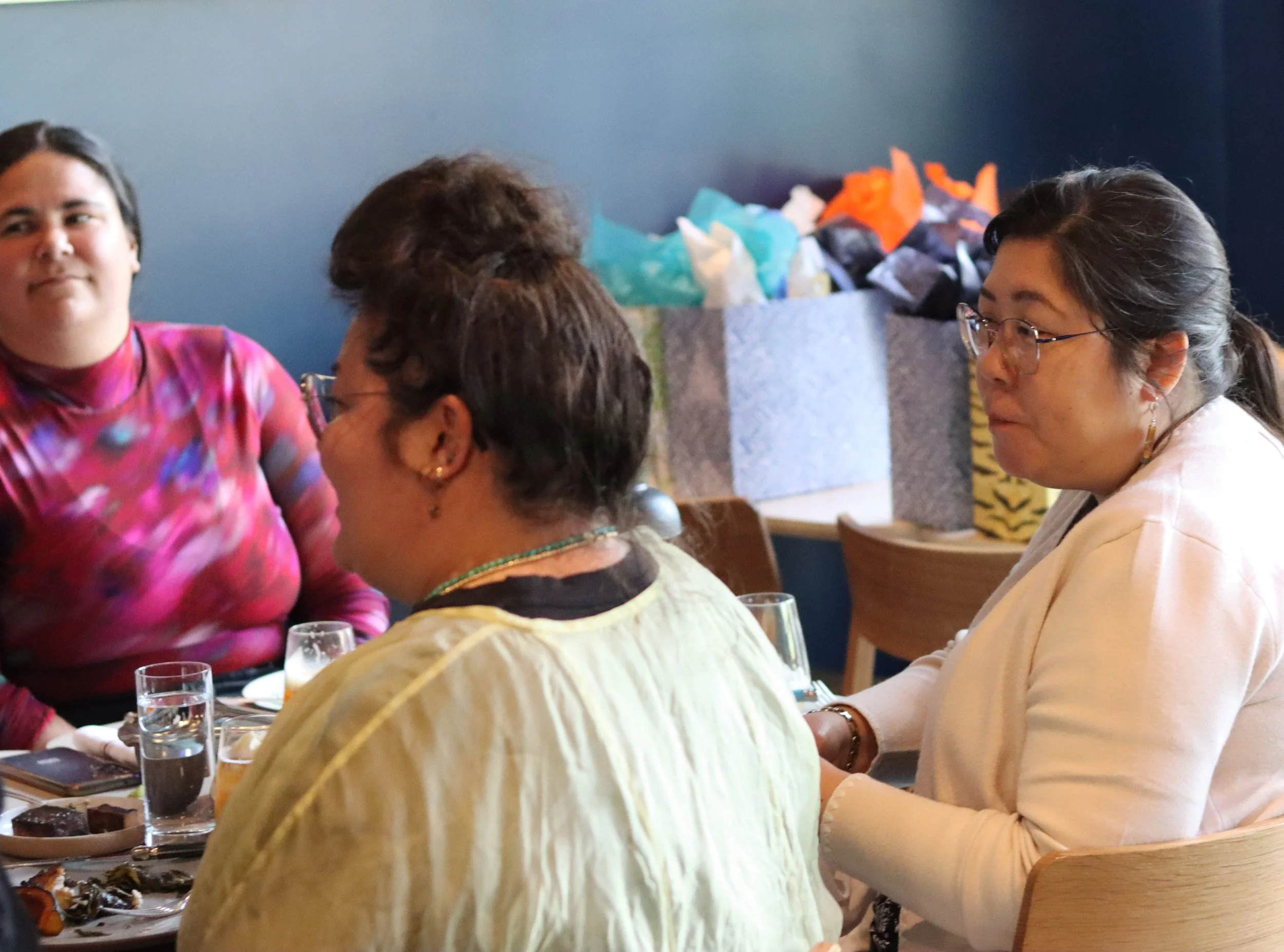 Three people seated at a table.