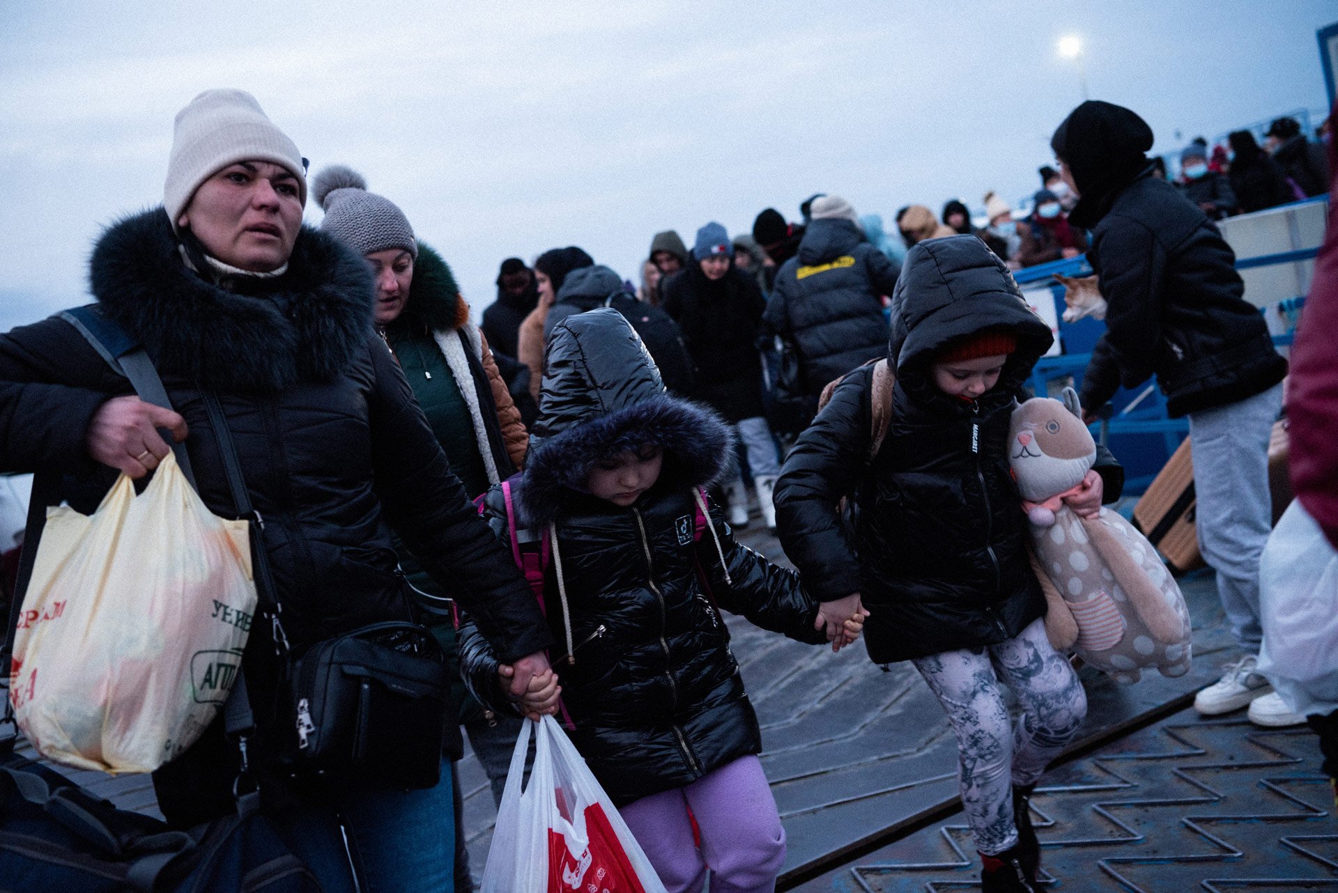 Ukrainian refugees getting of the boat that transfers them across the Dunabe, taking them to the border with Romania.