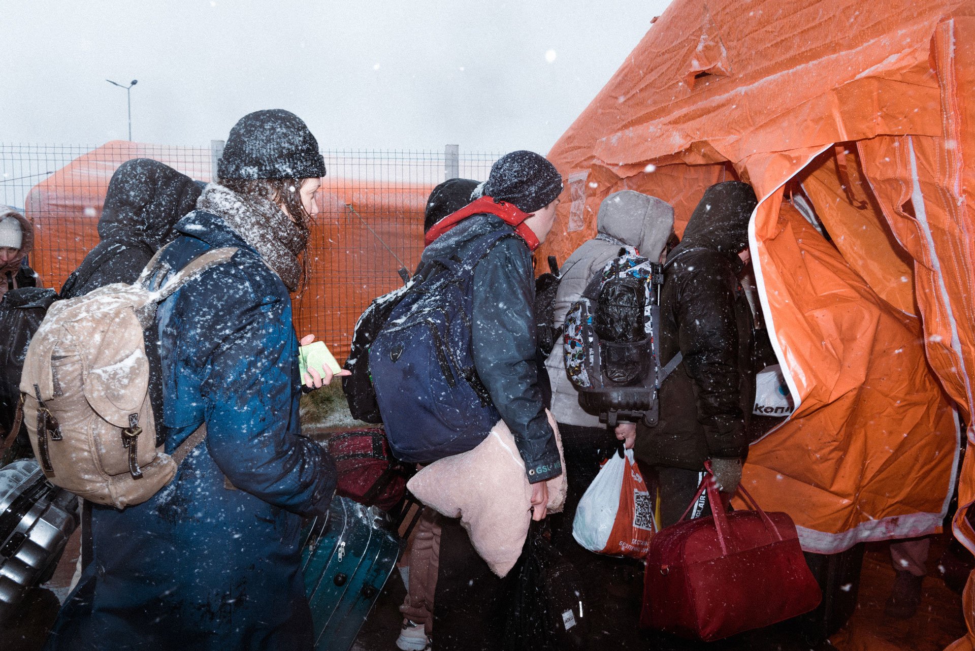 Ukrainian refugees arrive in a makeshift shelter near the Romanian border, through heavy snowfall and temperatures reaching -5°C.