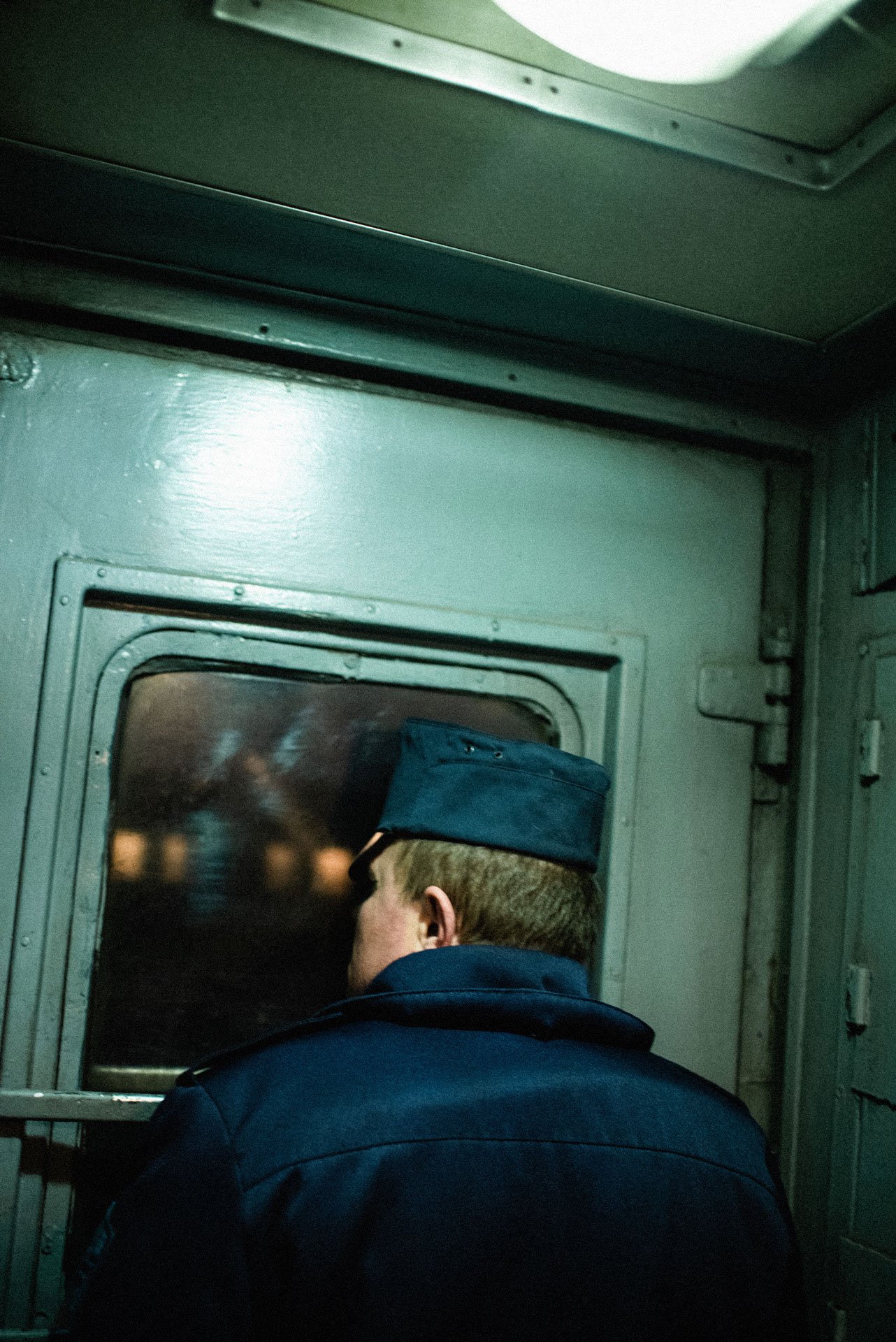A train conductor looks through the window as the coach arrives in Lviv, Ukraine.