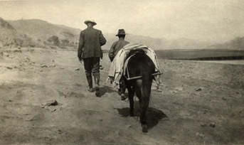 Rev. Watts O. Pye strides up a desert trail in Northwest China, around 1925. This photo helped inspire the ending for River of Dust and the overall sense in both novels that these Americans were pioneers in a rugged landscape that resembled our American West.