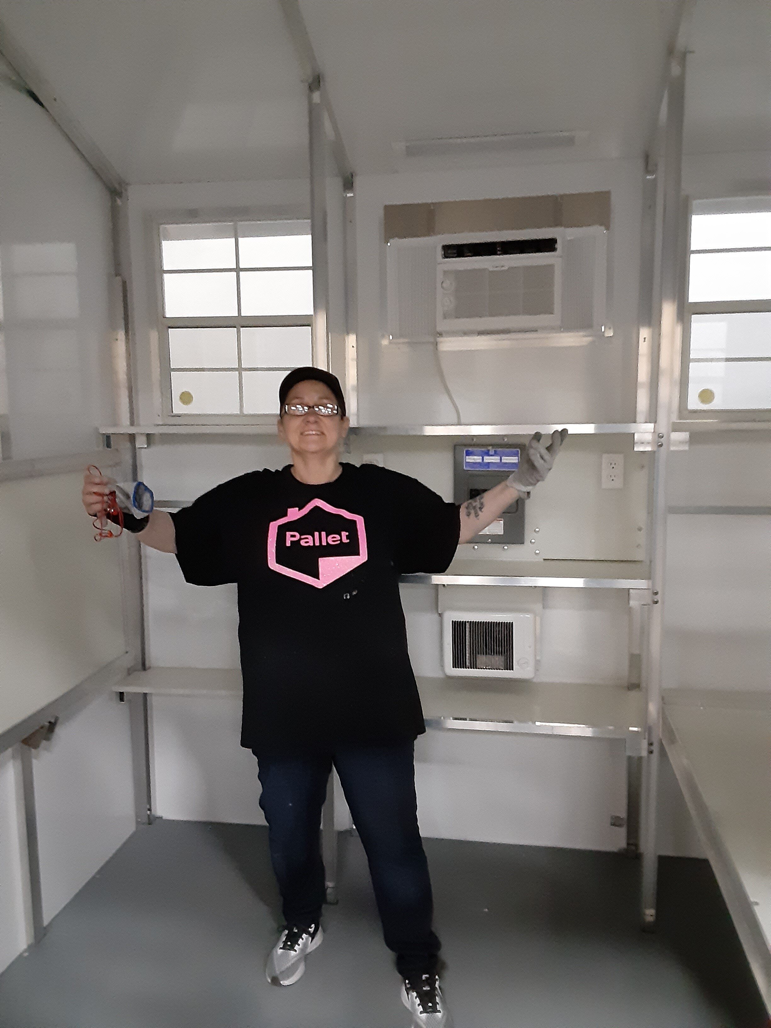 Daniece stands in a shelter she helped to build.