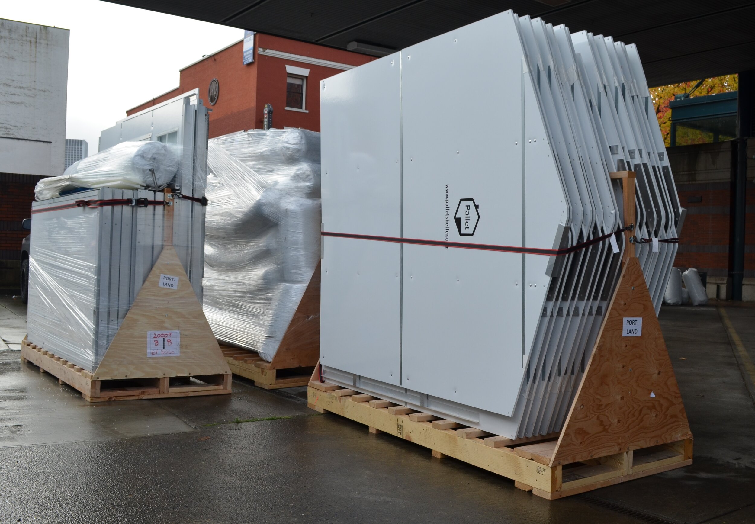 Pallet shelters panels are shipped on pallets. In this photo, the shelters are being unloaded in Portland, Oregon.