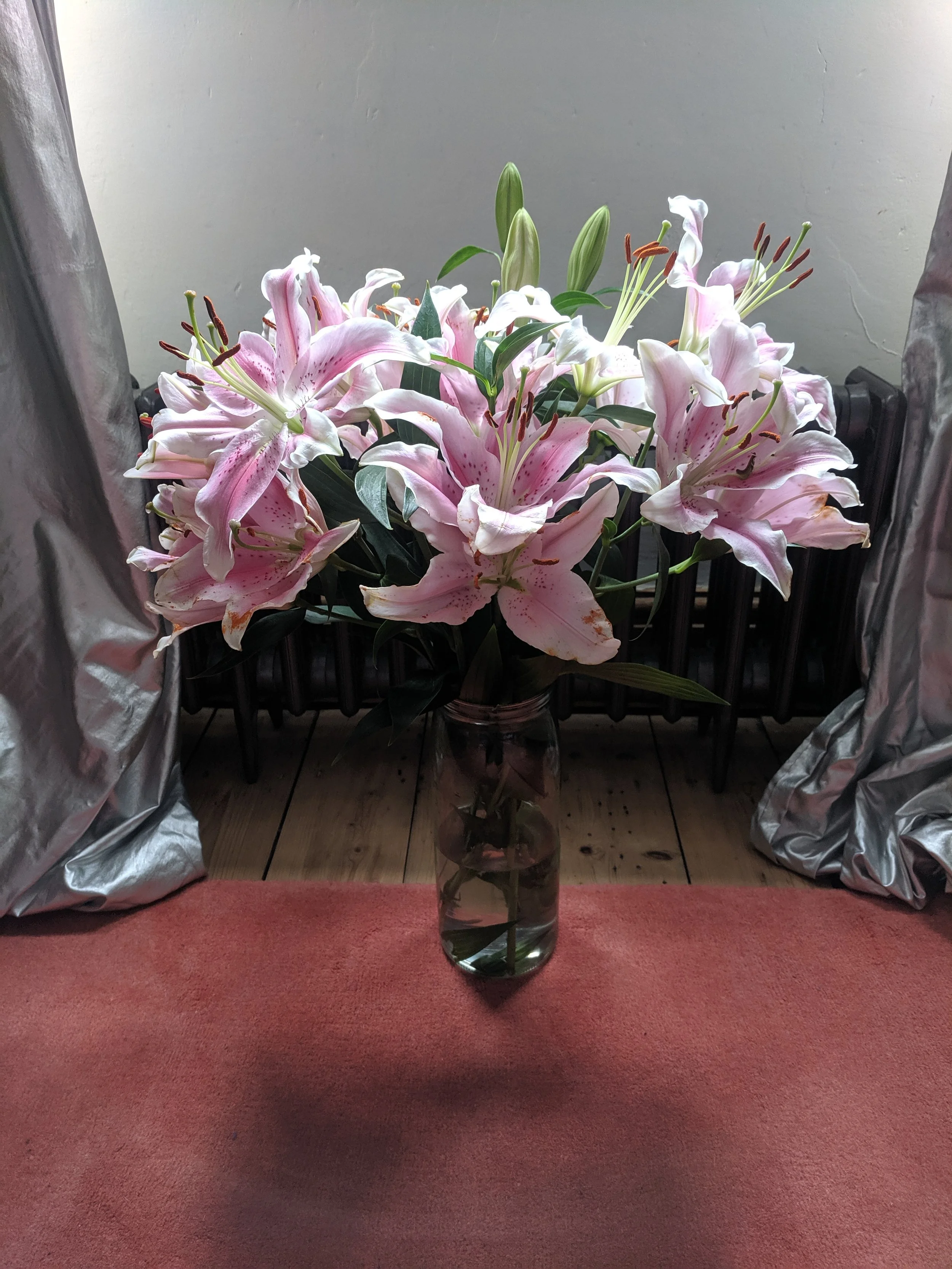 Flowers in front of silver curtains.jpg
