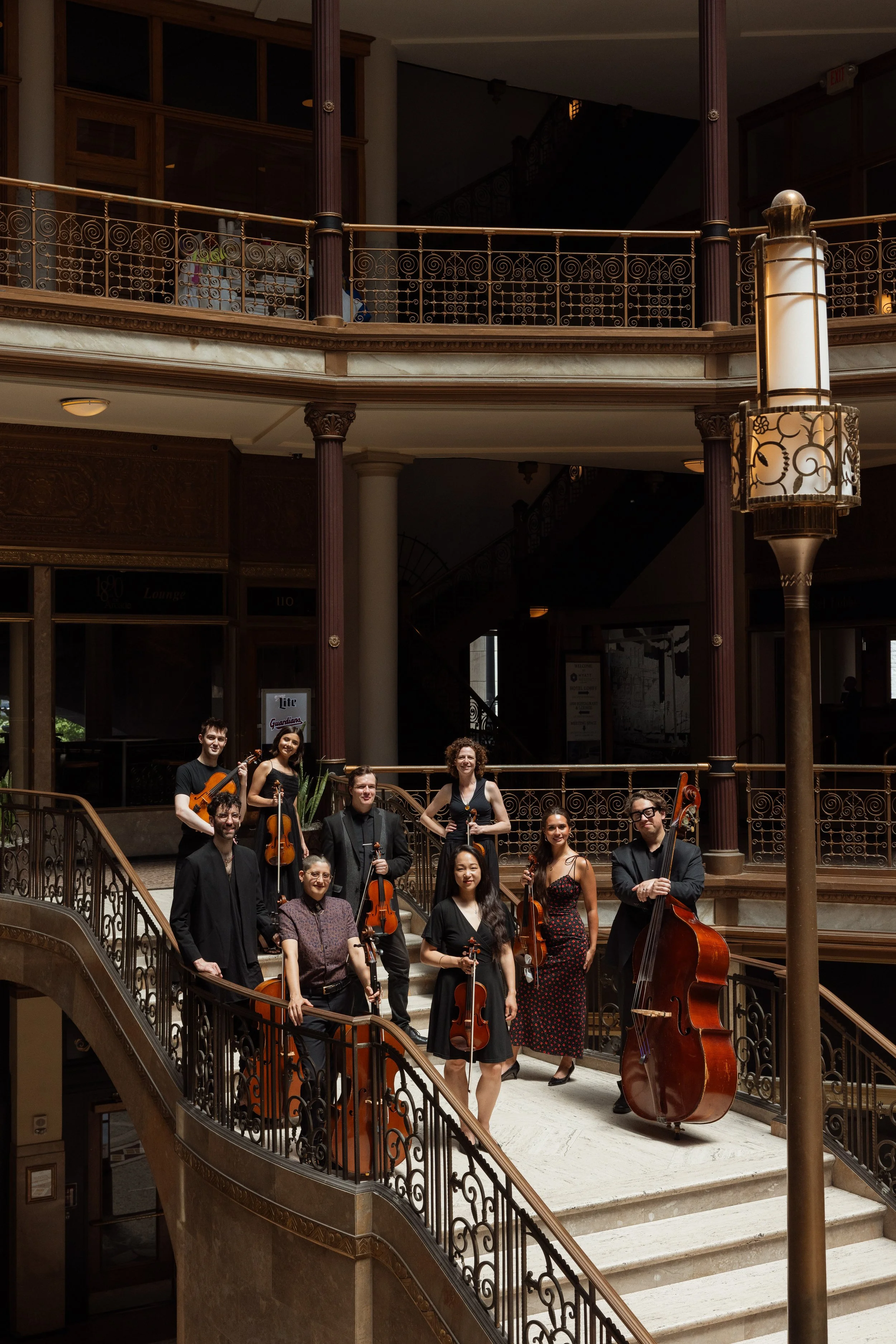 Members of Opus 216 standing on the stairs of the arcade