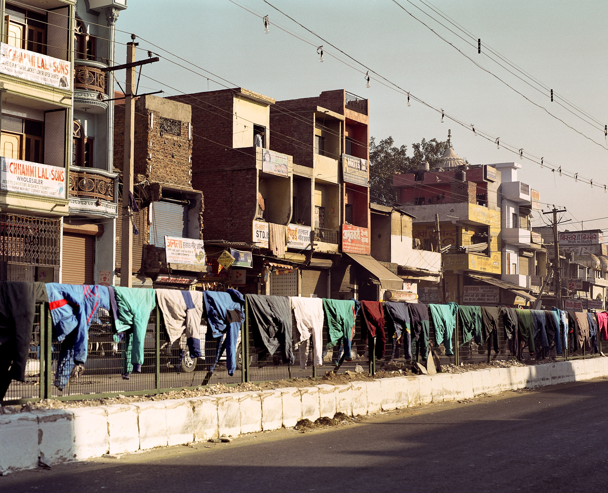 The local area is swathed with drying washing, festooning houses, draping over road barriers and strung across patches of wasteland.